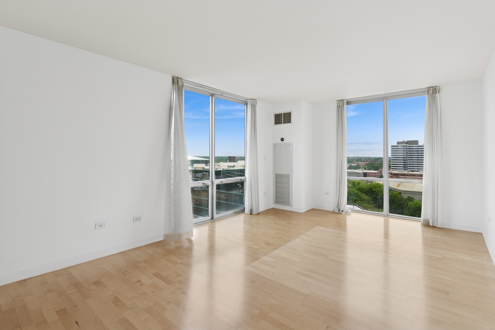 1640 Maple Avenue, Unit 1202 Evanston, IL 60201 - Photo 7 of 18 an empty room with wooden floor and windows