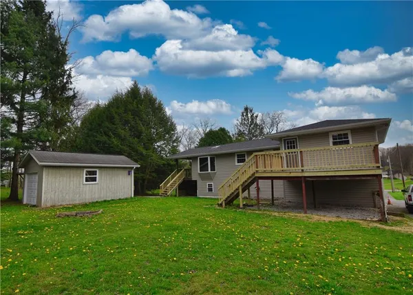 a view of a house with a backyard