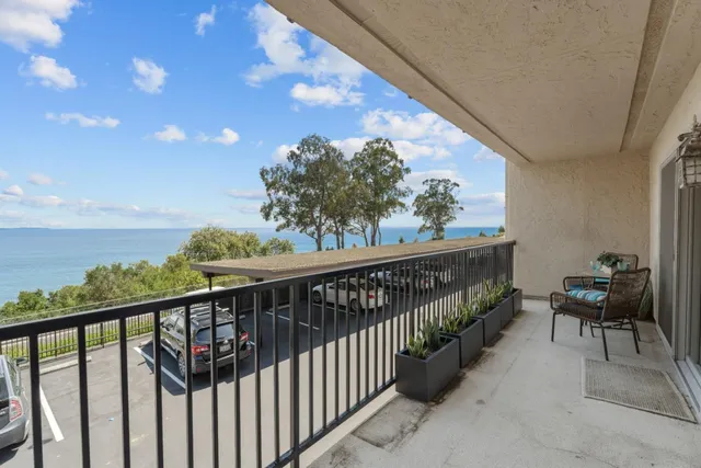 a view of a balcony with furniture