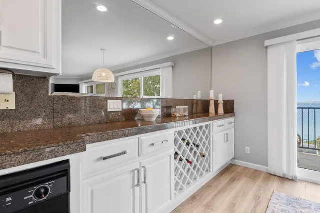 a kitchen with granite countertop a sink white cabinets and a granite counter tops