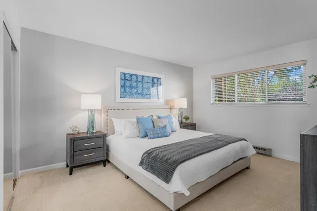 a bedroom with a bed a lamp and a window