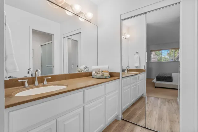 a bathroom with a tub sink and mirror