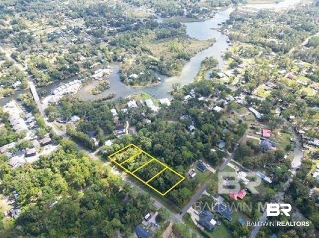 0 Coopers Landing Road Foley, AL 36535 - Photo 9 of 9 Aerial view of property and surrounding area with property boundaries highlighted and a large body of water