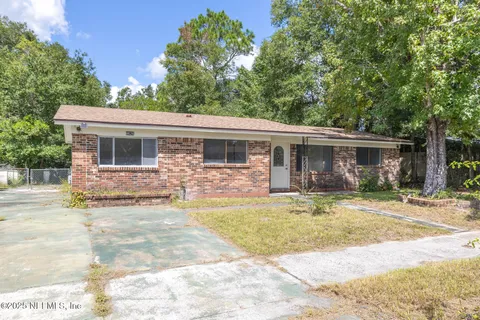 a view of a house with swimming pool and a yard