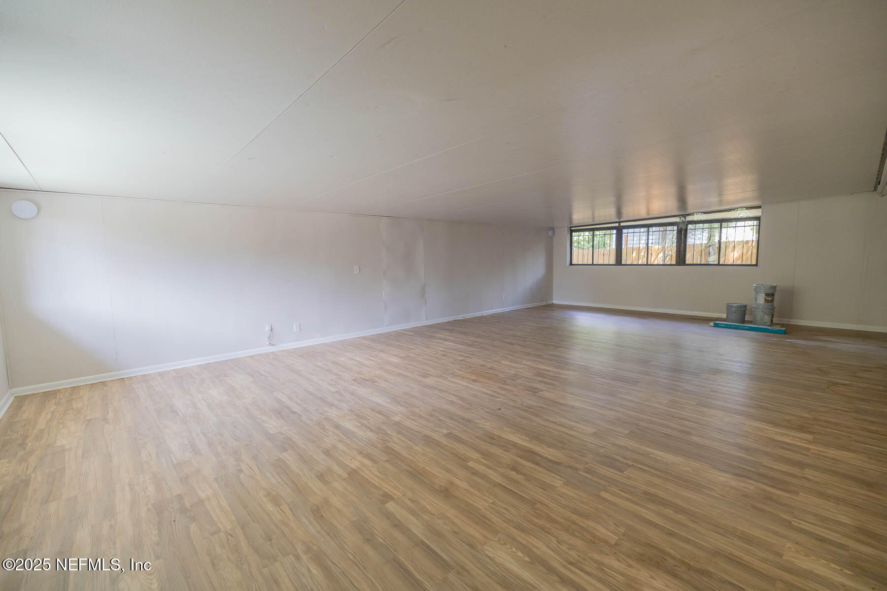 9626 Spottswood Road West Jacksonville, FL 32208 - Photo 13 of 16 an empty room with wooden floor and windows