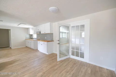 a view of a kitchen with wooden floor and electronic appliances