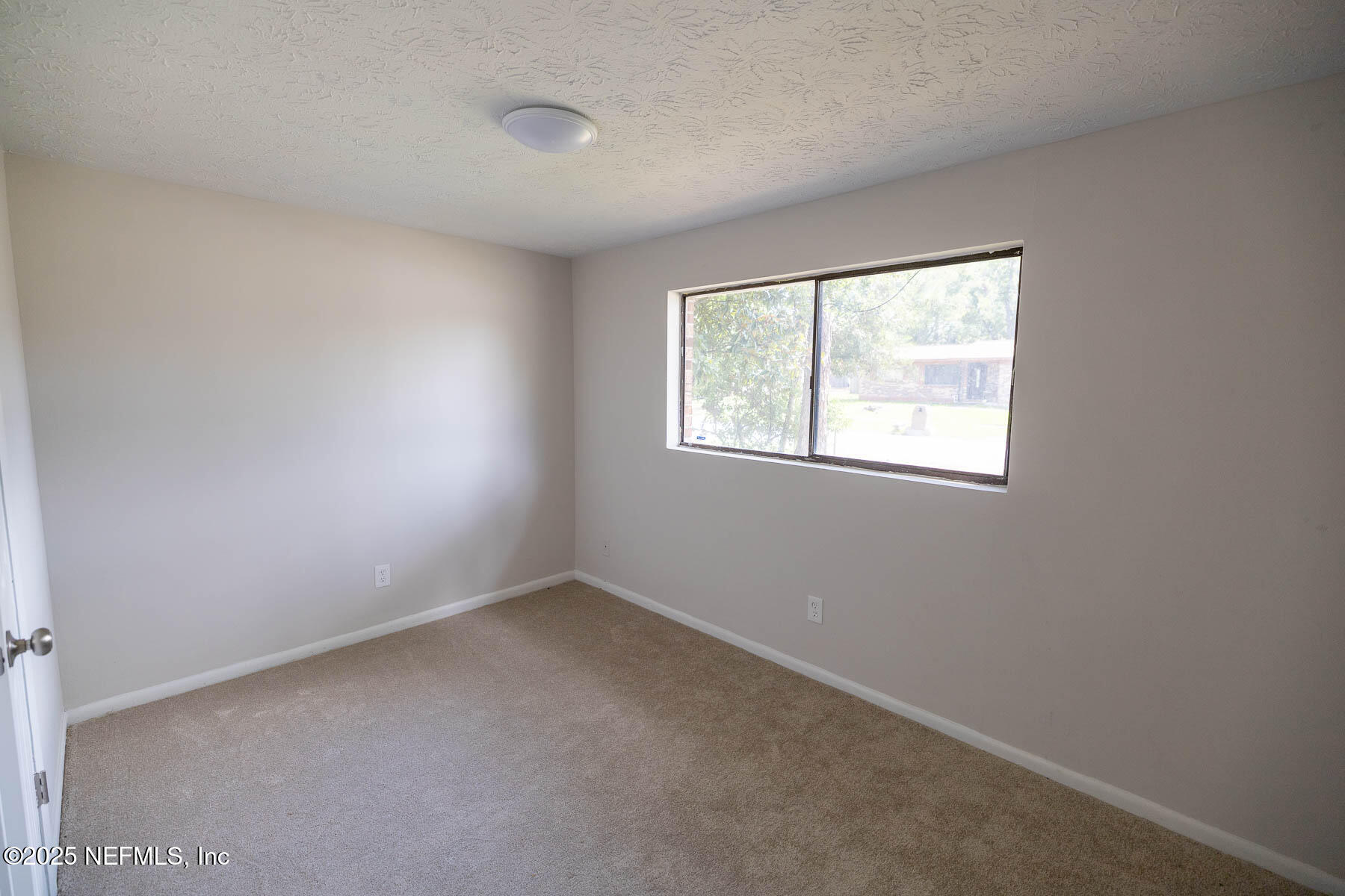 9626 Spottswood Road West Jacksonville, FL 32208 - Photo 6 of 16 an empty room with a window