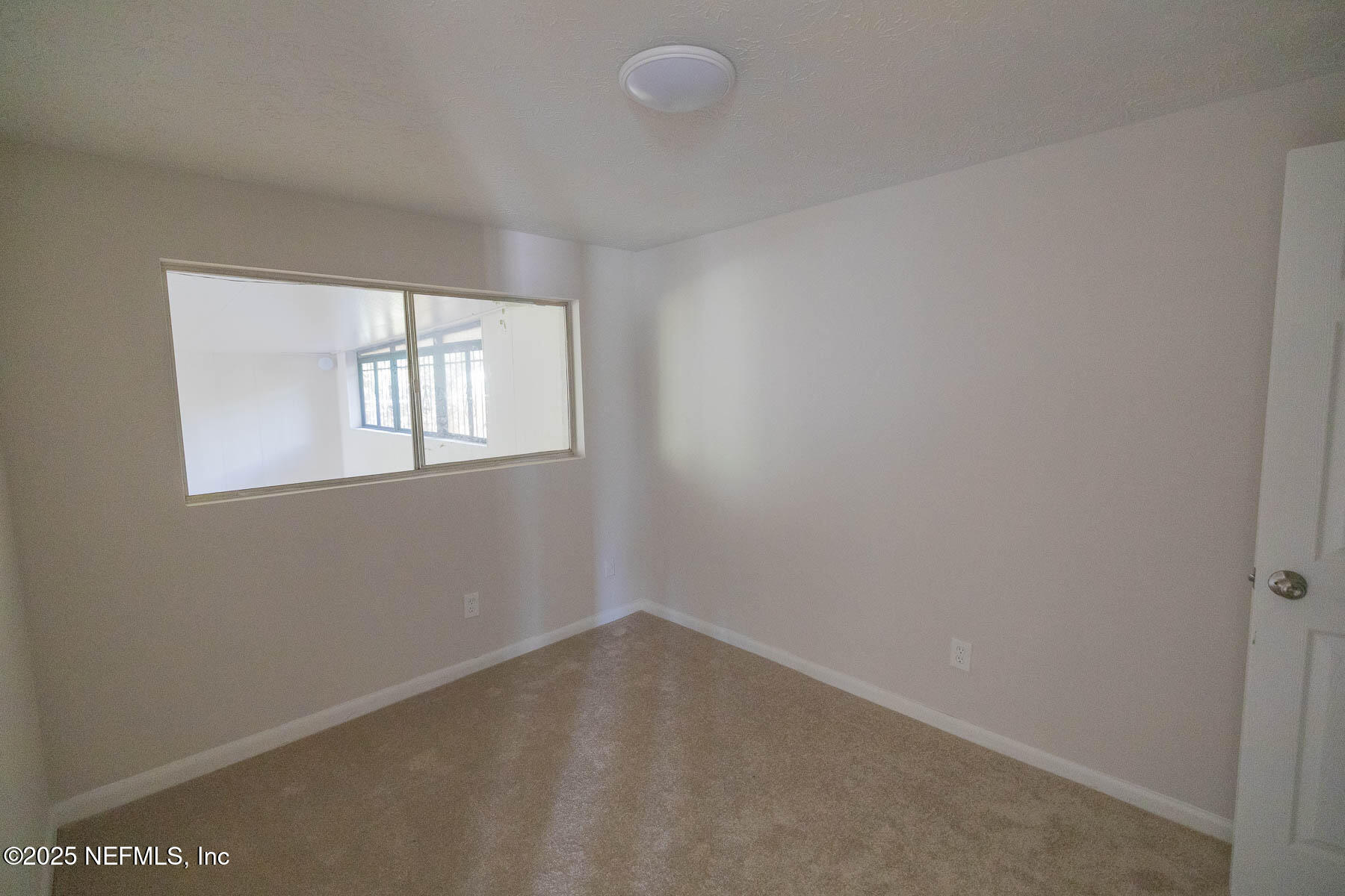 9626 Spottswood Road West Jacksonville, FL 32208 - Photo 7 of 16 an empty room with windows