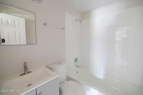 a bathroom with a sink toilet and vanity