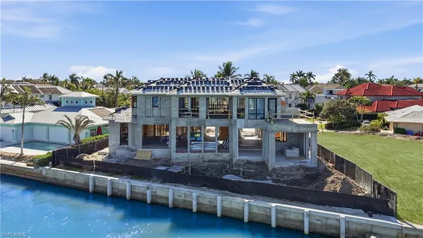 an aerial view of a house with a ocean view