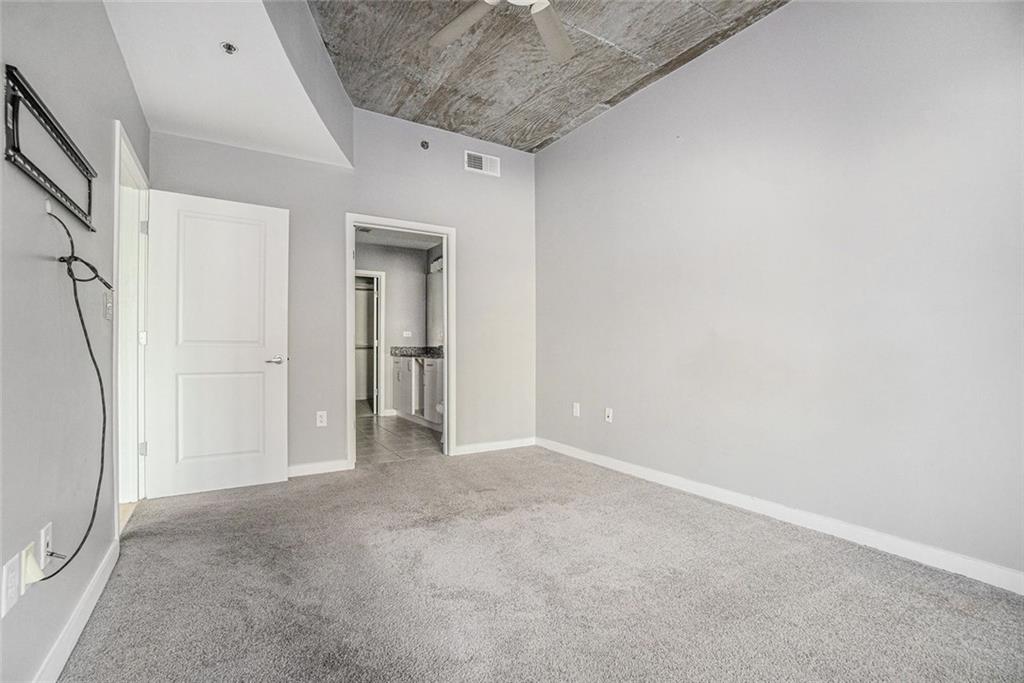 250 Pharr Road Northeast, Unit 405 Atlanta, GA 30305 - Photo 11 of 20 a view of an empty room with a window