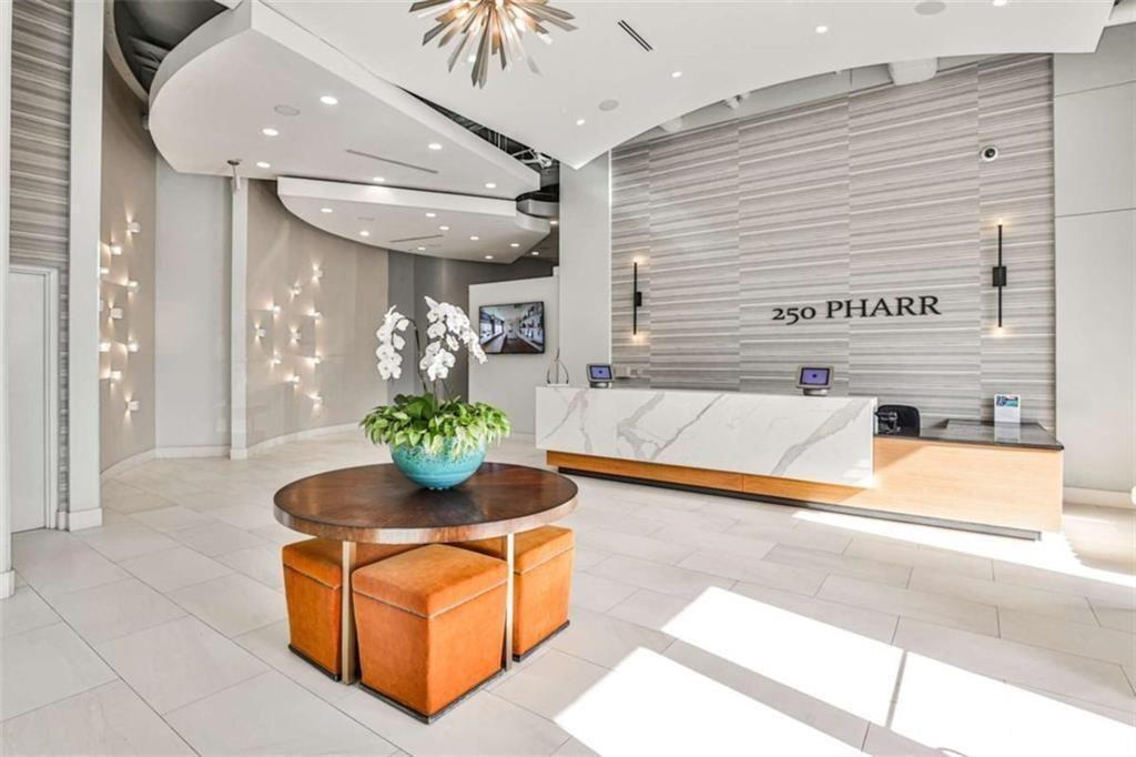 250 Pharr Road Northeast, Unit 405 Atlanta, GA 30305 - Photo 17 of 20 a living room with stainless steel appliances kitchen island granite countertop furniture a rug and a window