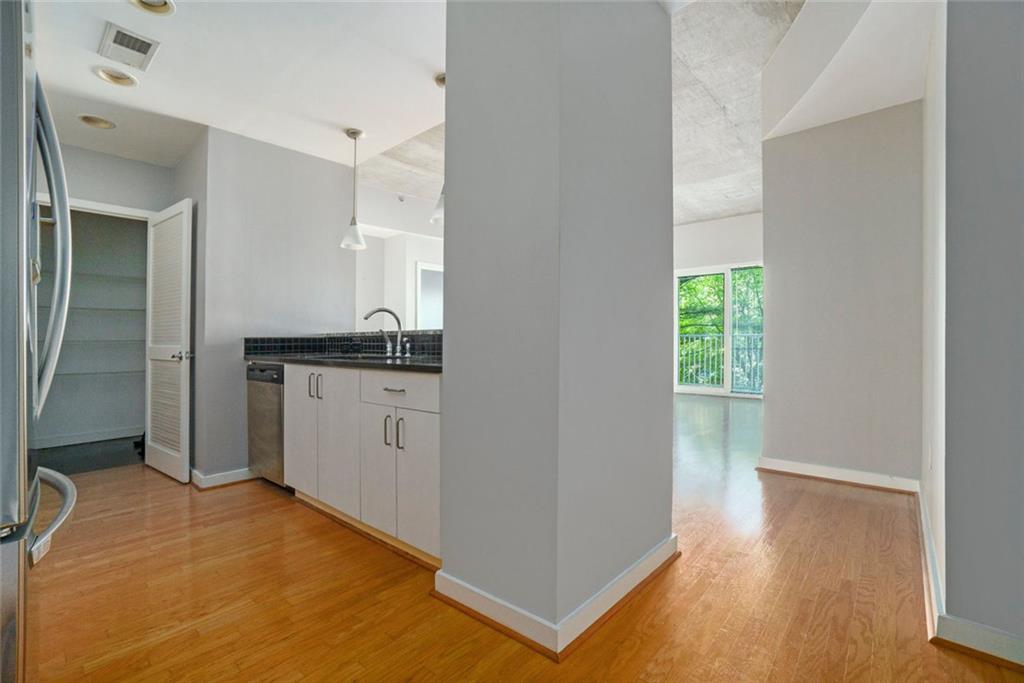 250 Pharr Road Northeast, Unit 405 Atlanta, GA 30305 - Photo 5 of 20 a kitchen with a sink cabinets and wooden floor