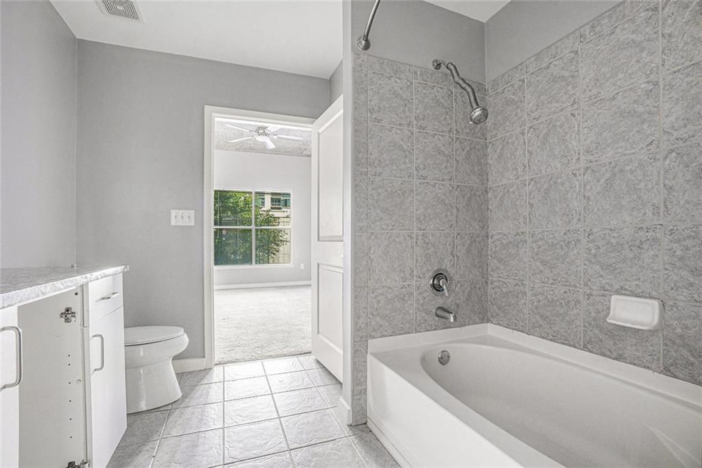 250 Pharr Road Northeast, Unit 405 Atlanta, GA 30305 - Photo 8 of 20 a bathroom with a bathtub and a toilet