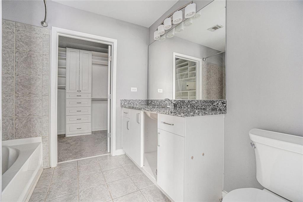 250 Pharr Road Northeast, Unit 405 Atlanta, GA 30305 - Photo 9 of 20 a bathroom with a granite countertop sink and a mirror