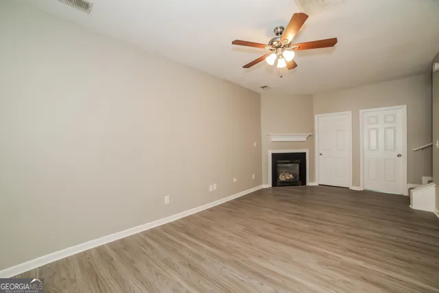 wooden floor in an empty room with a fireplace