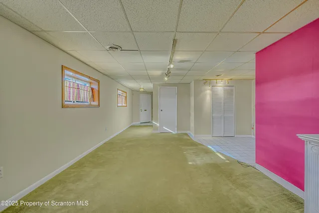 a view of a room with window and chandelier