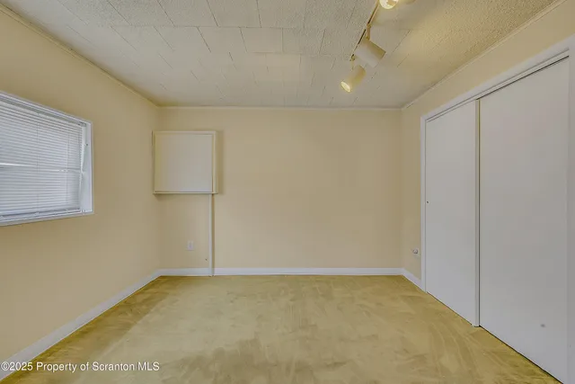 a view of a hallway with a window