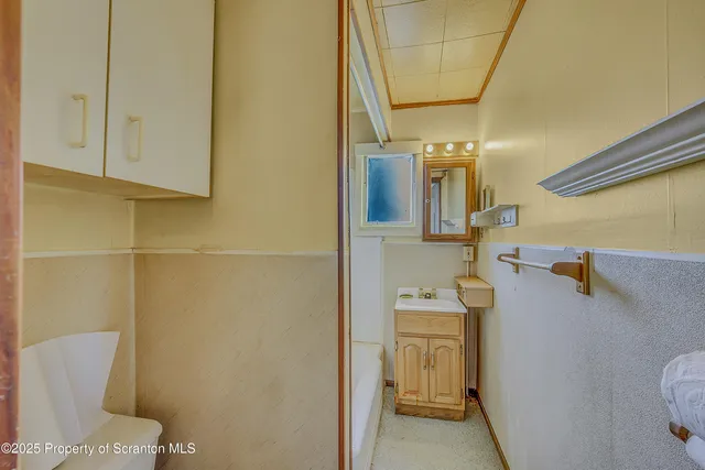 a bathroom with a sink a toilet and mirror
