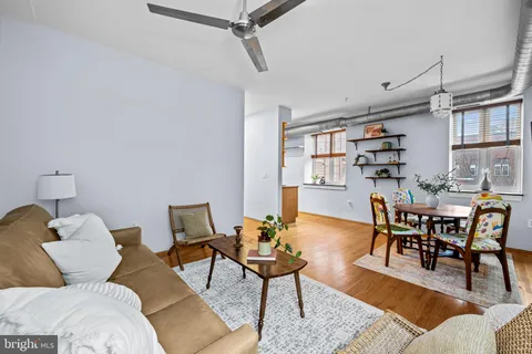 a living room with furniture and a wooden floor