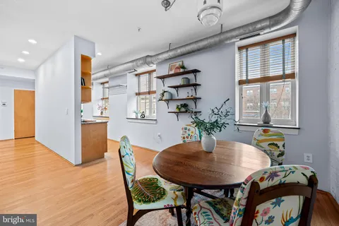 a view of a dining room with furniture and wooden floor
