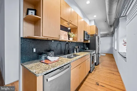 a kitchen that has a sink and a wooden floor