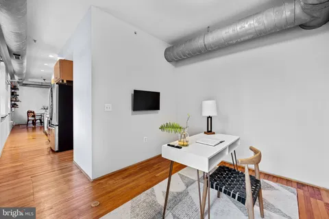 a workspace with furniture and wooden floor