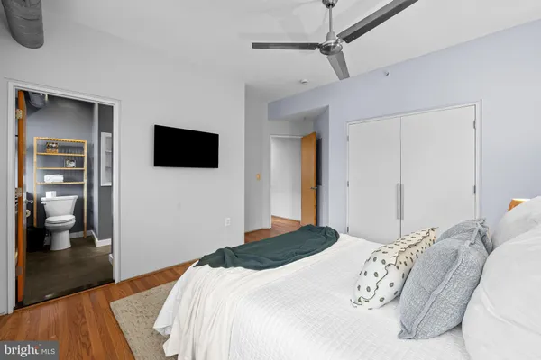 a bedroom with a bed and a television