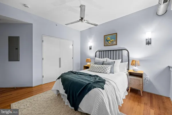 a bedroom with a bed and wooden floor