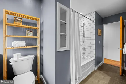 a bathroom with a toilet and a shower