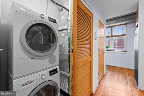 a view of a hallway with washer and dryer