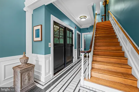 a view of entryway and hall with wooden floor