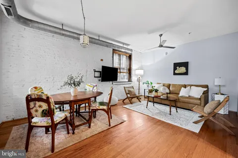a living room with furniture a rug and a table