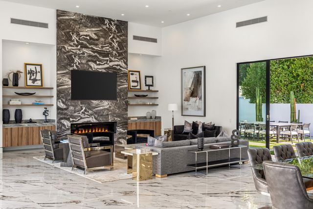 a living room with fireplace furniture and a flat screen tv