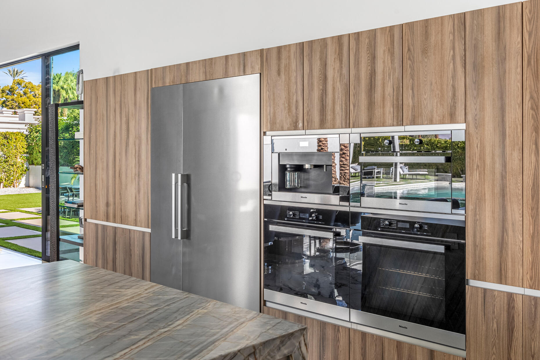 2 Bravo Court Rancho Mirage, CA 92270 - Photo 7 of 34 a kitchen with granite countertop a refrigerator stove and cabinets