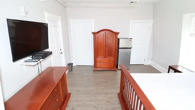 a bedroom with a bed and a flat screen tv