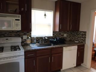10641 South Sangamon Street Chicago, IL 60643 - Photo 3 of 16 a kitchen with sink a microwave a stove and cabinets