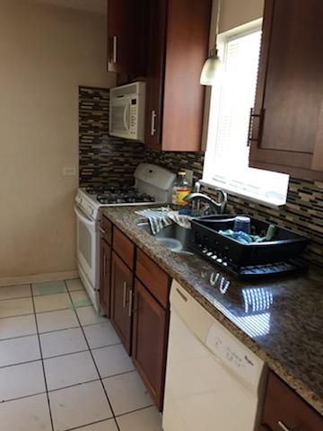 10641 South Sangamon Street Chicago, IL 60643 - Photo 4 of 16 a kitchen with a stove a sink and a microwave