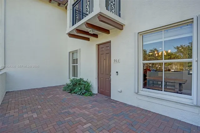 a view of a street with potted plants