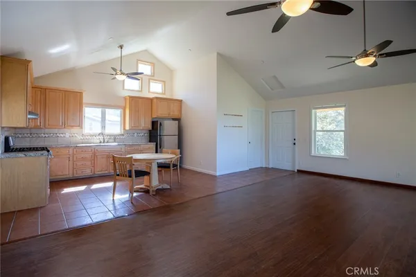 an open kitchen with dining table and chairs