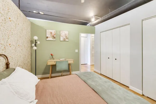 a bedroom with a bed and a table