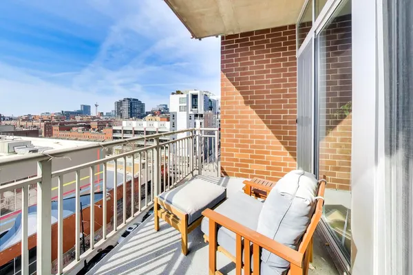 a view of a balcony with a table and chairs