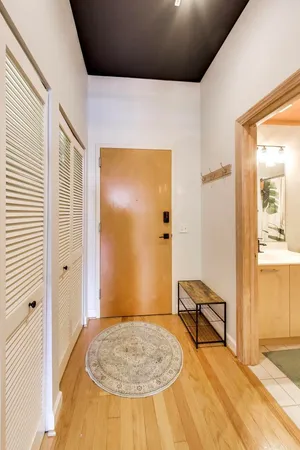 a view of livingroom with hardwood floor and a bathroom