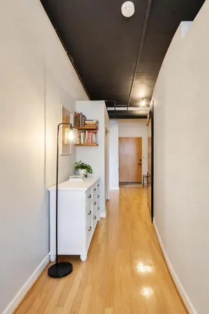 a view of hallway with wooden floor