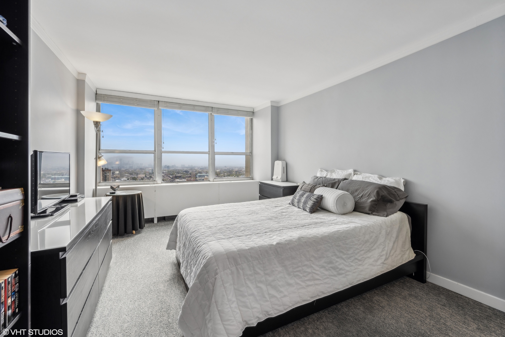 655 West Irving Park Road, Unit 5413 Chicago, IL 60613 - Photo 12 of 23 a bedroom with a bed and large windows