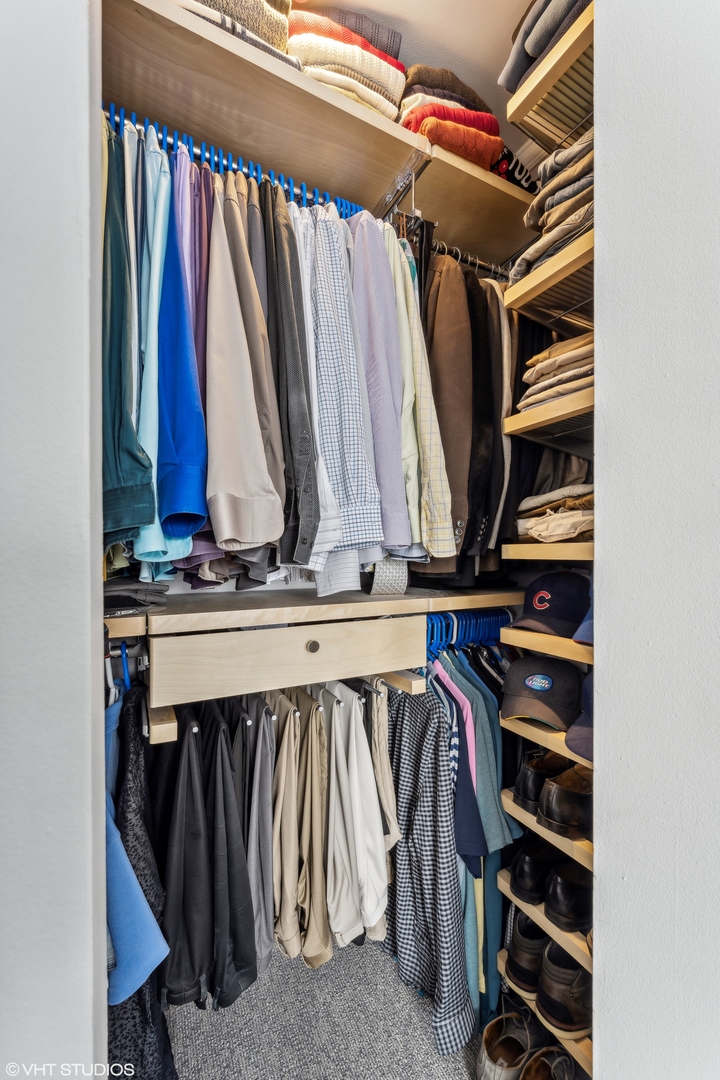655 West Irving Park Road, Unit 5413 Chicago, IL 60613 - Photo 14 of 23 a view of walk in closet with clothes and shoes