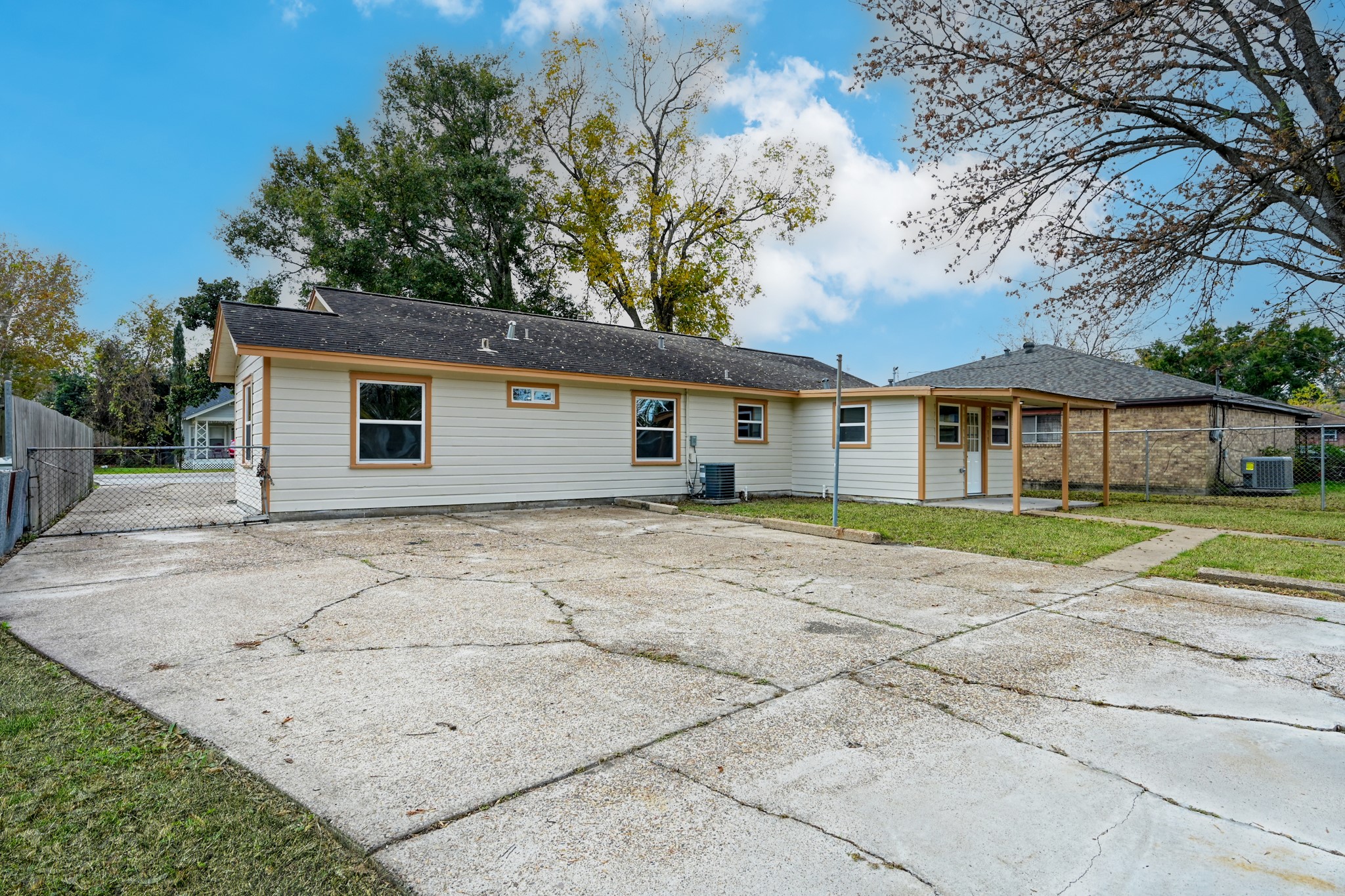 513 Barkley Street Houston, TX 77022 - Photo 47 of 48 Charming single-story home with a spacious driveway and fenced yard. Features a covered entrance and mature trees, offering a cozy suburban feel.