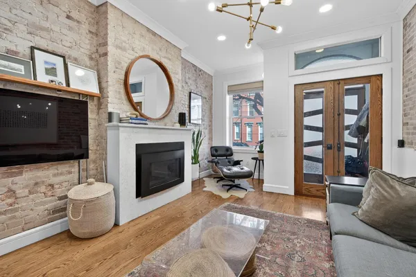 a living room with furniture a flat screen tv and a fireplace
