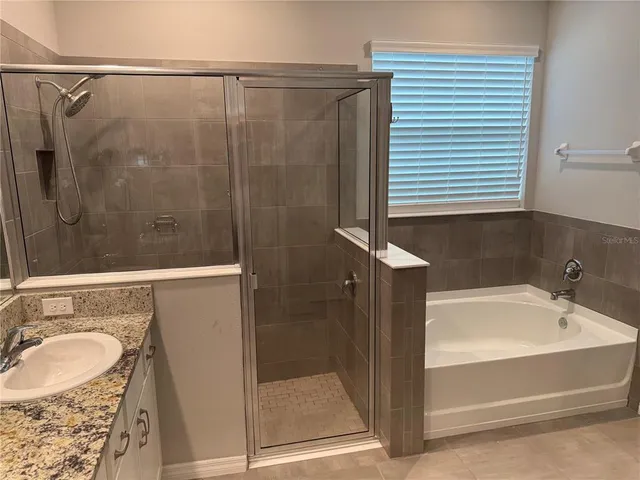 a bathroom with a shower and a sink