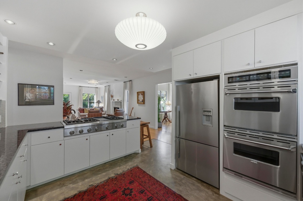 1712 West 10th Street Austin, TX 78703 - Photo 34 of 34 a kitchen with stainless steel appliances a sink stove and refrigerator